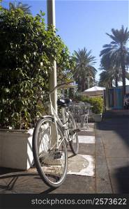 Bicycle parked against a pole, Miami, Florida, USA