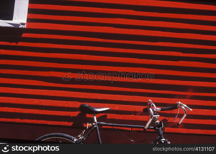 Bicycle parked against a wall