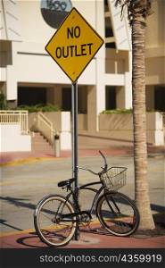 Bicycle parked against an information board, Miami, Florida, USA