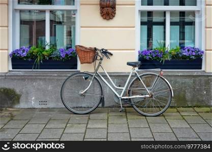 Bicycle parked near the house in the Hague, the Netherlands. Bicycle is a very popular means of transport in the Netherlands. Bicycle parked near the house in the Netherlands