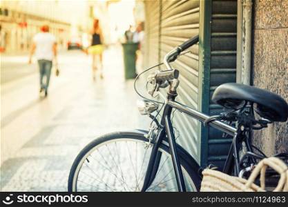 Bicycle parked on the european street close up, Portugal. Bicycle on the european streer