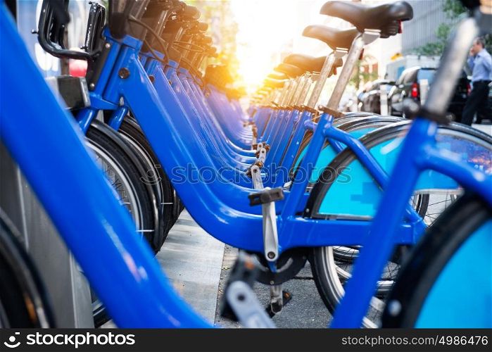 Bicycle rental service spot on city street. Public transportation concept.