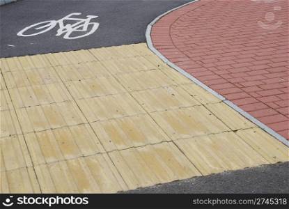 bicycle sign/lane in a urban place with two colorful pavements