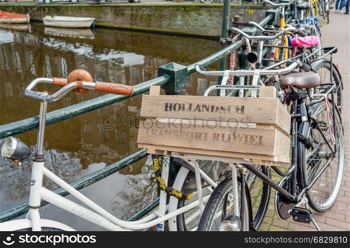 Bicycle standing against a bridge railing in Amsterdam.