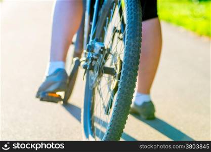 bicycle wheel and foot girl close-up