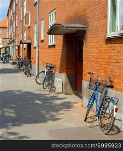 Bicycles along the apartmnent building wall. Copenhagen, Denmark