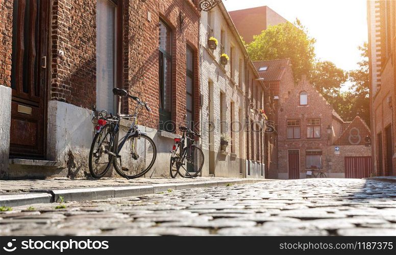 Bicycles at old building facade on cozy street, old provincial European town. Summer tourism and travels, famous europe landmark, popular places. Bicycles at old building facade, cozy street