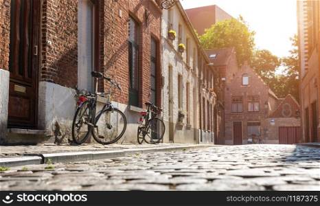 Bicycles at old building facade on cozy street, old provincial European town. Summer tourism and travels, famous europe landmark, popular places. Bicycles at old building facade, cozy street