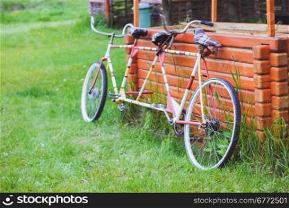 Bicycles for two passengers, the tandem on the green grass