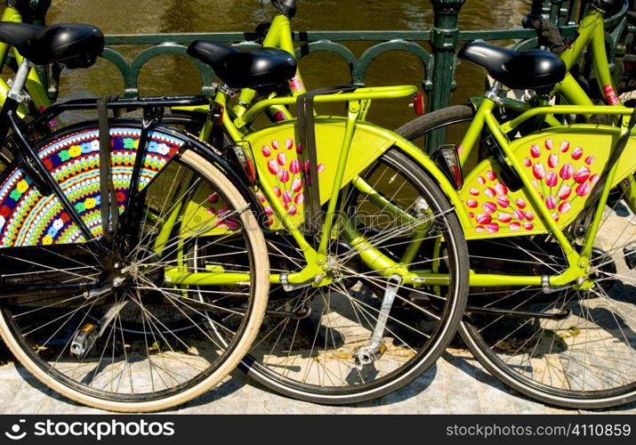 Bicycles locked to railings on canal, Holland