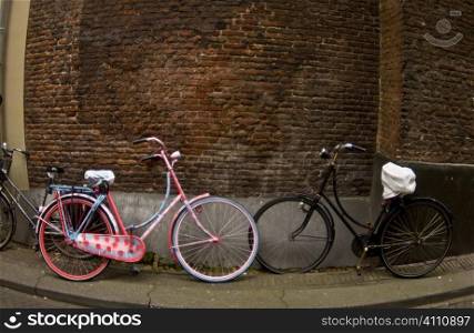 Bicycles parked against brick wall, Holland