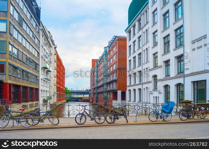 Bicycles parking by canal at street of Hamburg, Germany