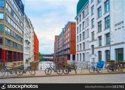 Bicycles parking by canal at street of Hamburg, Germany
