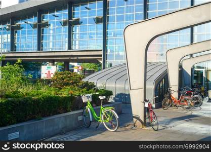 Bicycles parking by Kastrup airport entrance in evening sunshine, Copenhagen, Denmark