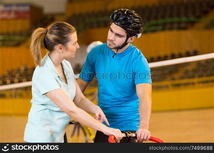 bicyclist and trainer at velodrome