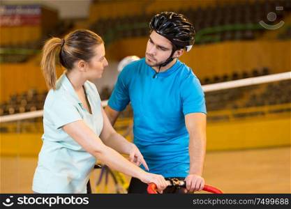 bicyclist and trainer at velodrome