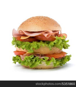 Big appetizing fast food sandwich with lettuce, tomato, smoked ham and cheese isolated on white background. Junk food hamburger.