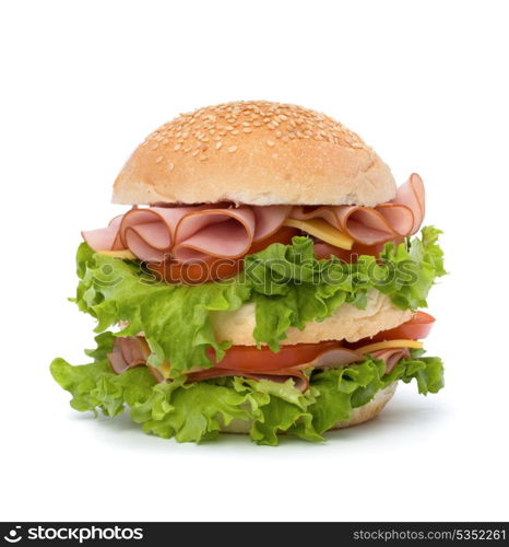 Big appetizing fast food sandwich with lettuce, tomato, smoked ham and cheese isolated on white background. Junk food hamburger.