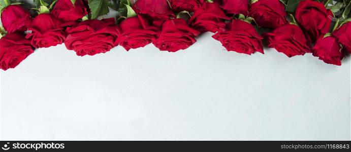 Big beautiful bouquet of red roses. A gift for a wedding birthday Valentine&rsquo;s Day roses. Space for text and design with roses. Flat lay copyspace roses.. Roses on a white conctere background.