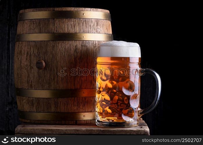 Big beer mug and beer barrel on wooden table still life