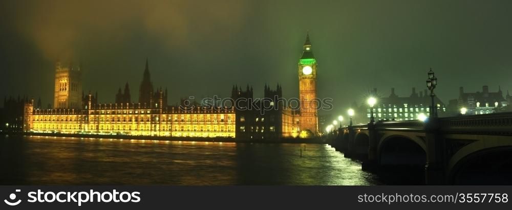 Big Ben at night along with the lights of the cars passing by