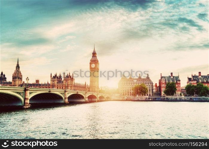Big Ben, Westminster Bridge on River Thames in London, the UK. English symbol. Sunset sky with some clouds. Vintage. Big Ben, Westminster Bridge on River Thames in London, the UK. Vintage