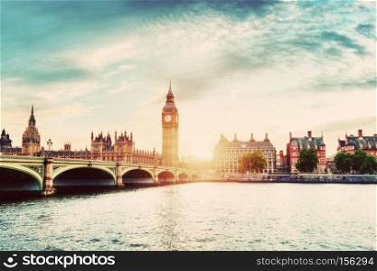Big Ben, Westminster Bridge on River Thames in London, the UK. English symbol. Sunset sky with some clouds. Vintage. Big Ben, Westminster Bridge on River Thames in London, the UK. Vintage
