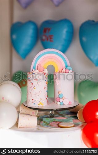 big Birthday cake with rainbow, colorful Sprinkles. on many colorful heart balloons background. birthday party. sweet holiday. big Birthday cake with rainbow, colorful Sprinkles. on many colorful heart balloons background. birthday party. sweet holiday.