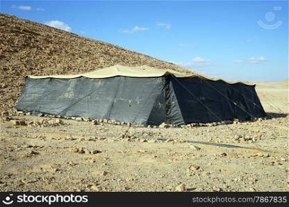 Big black tent and hill in Negev desert, Israel