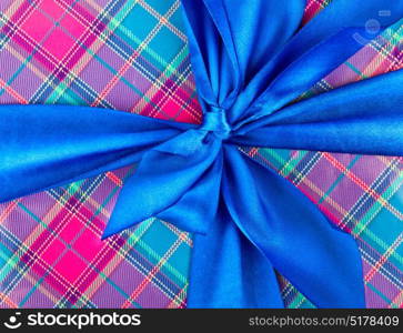 Big blue holiday bow on ornamental background