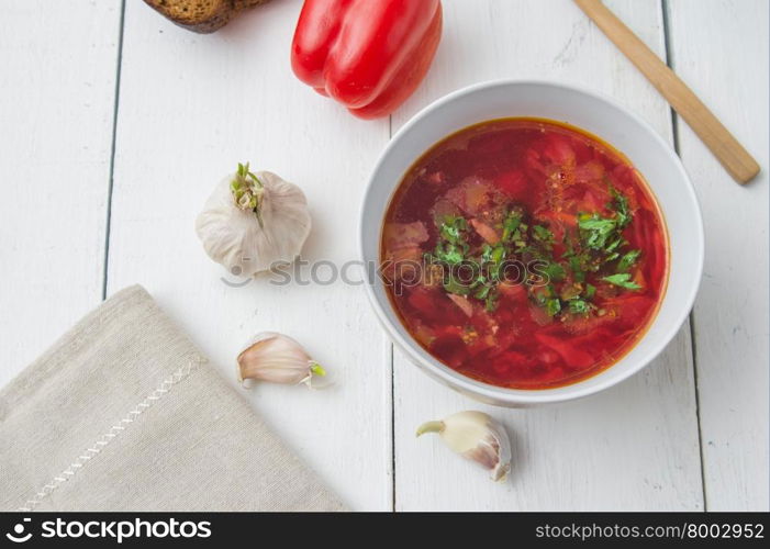 big bowl of borscht with herbs on table