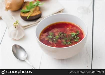 big bowl of borscht with herbs on table