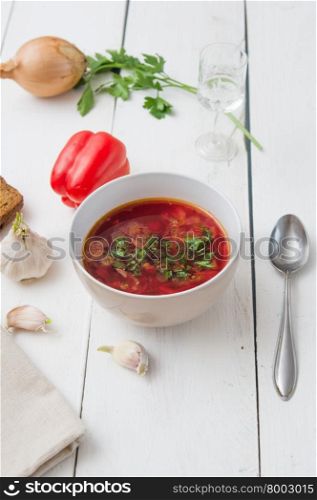 big bowl of borscht with herbs on table