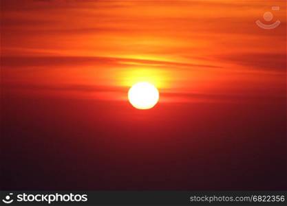 big bright sun on red and yellow sky background
