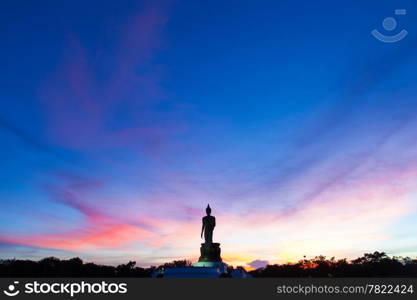 Big Buddha in the evenings. Within the park. Sky sun sets.