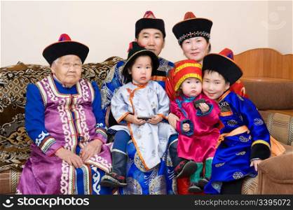 big buryat (mongolian) family: grandmother, grandson with wife and children, in national costumes