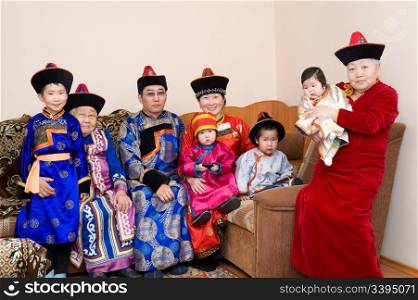 big buryat (mongolian) family: great grandmother, grandmother, son with wife and their children, in national costumes