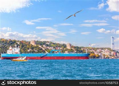 Big cargo ship in the Bosphorus near the Rumelian castle, Istanbul.