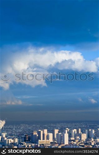 big city under high blue sky with white clouds