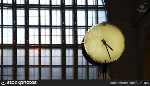 Big clock inside a train station with big window