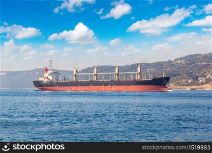 Big container ship in Dardanelles strait, Turkey in a beautiful summer day