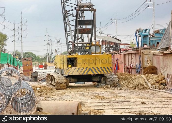 big crane in construction site. hard equipment is working in building area.