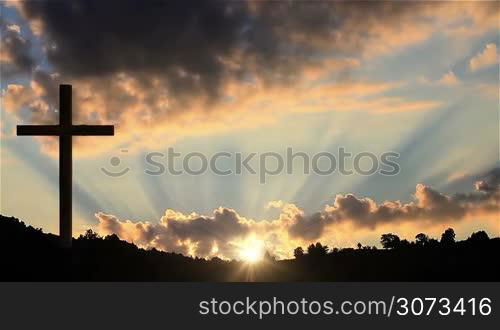 Big Cross at sunset. One Christian cross on a hill at sunset.