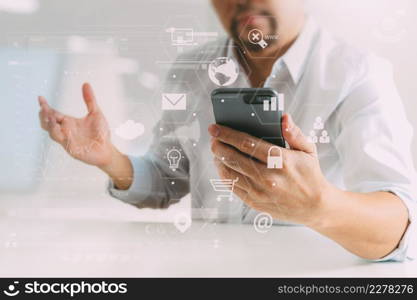 Big data analytics with business intelligence (BI) concept. businessman using mobile phone and laptop computer on white desk with VR chart and graph with icon