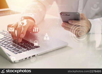 Big data analytics with business intelligence (BI) concept. businessman using mobile phone and laptop computer on white desk with VR chart and graph with icon