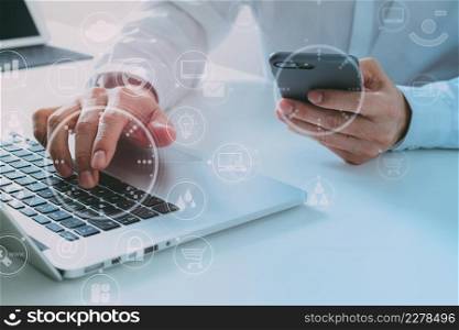 Big data analytics with business intelligence (BI) concept. businessman using mobile phone and laptop computer on white desk with VR chart and graph with icon