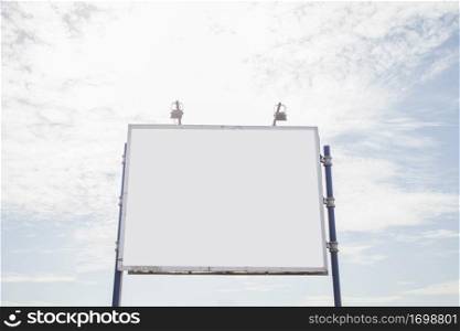 big empty billboard with two lamp against sky