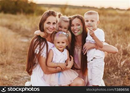 Big family is relaxing together in green nature. Mother&rsquo;s Day. happy family together. two moms with children. selective focus.. Big family is relaxing together in green nature. Mother&rsquo;s Day. happy family together. two moms with children. selective focus