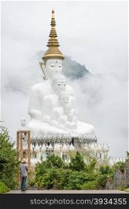Big Five sitting Buddha statues in misty morning at Wat Pha Sorn Kaew in Petchabun, Thailand