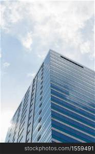 Big glass building with blue sky and white cloud